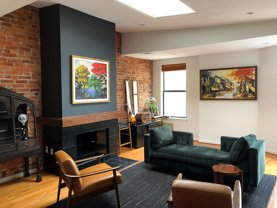 Living/dining room with exposed brick walls