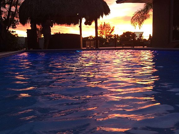 Swimming Pool and Tiki Hut at Sunset