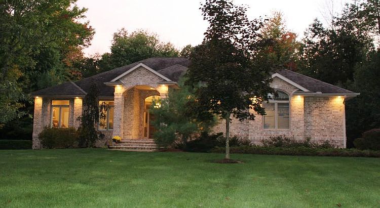 Inviting covered entrance and custom exterior lighting.