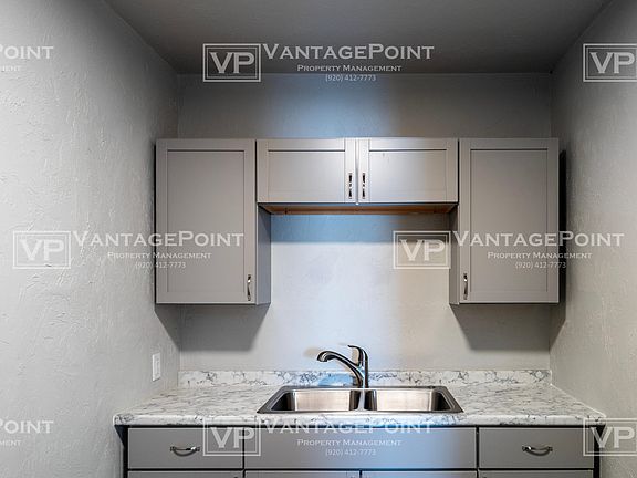 Kitchen cabinets with stainless steel sink.