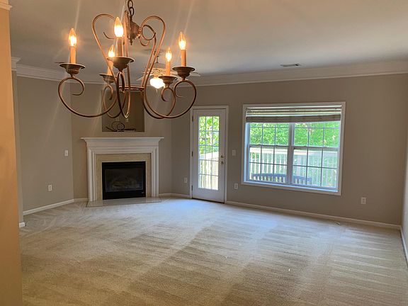 Living and dining area with gas logs. Opens to sunny private deck