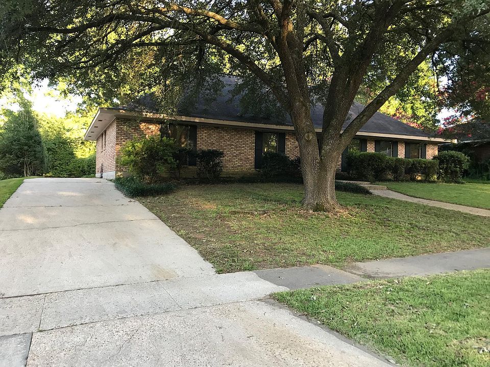 Driveway wraps around the back of the house