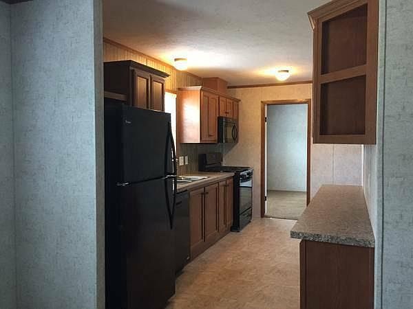 Kitchen: All new sleek black appliances. Range, refrigerator