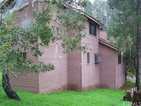 West side of home with bedrooms to the left, kitchen in middle and living room to right in picture.