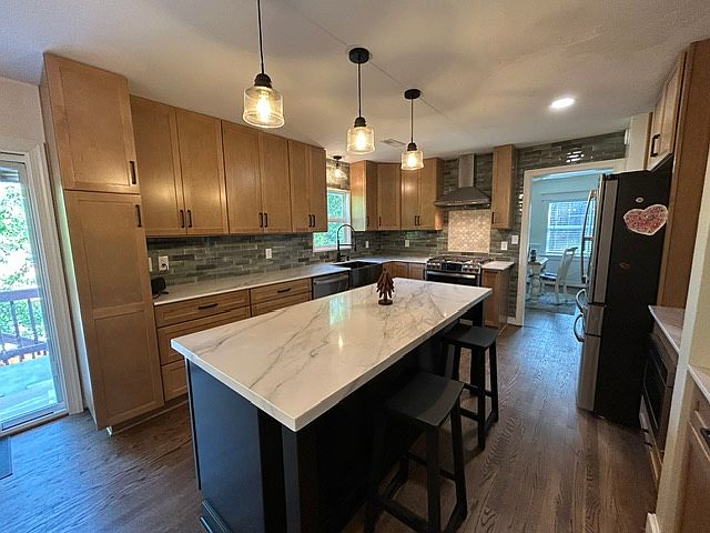 Completely remodeled kitchen features all new cabinets, quartz countertops, new appliances including gas stove with dual ovens, beautiful new backsplash tile and refinished hardwood floors.