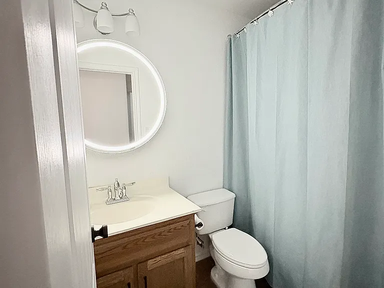 The guest bathroom includes a stylish new mirror that doubles as a medicine cabinet and features a convenient defogging function.