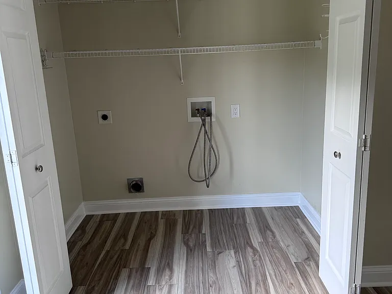 Laundry room with storage shelves.