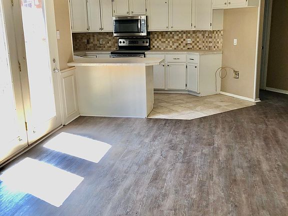 Nice open kitchen with kitchen bar. double glass doors to the patio. Plenty of cabinet space with new microwave/ corner sink and dishwasher