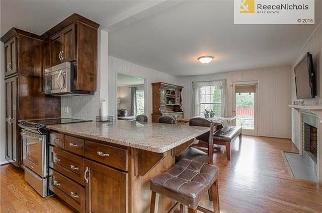 Completely renovated kitchen with granite counters. Island/bar opens to dining/hearth room.