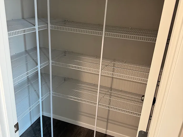 Pantry located at garage entry next to kitchen.