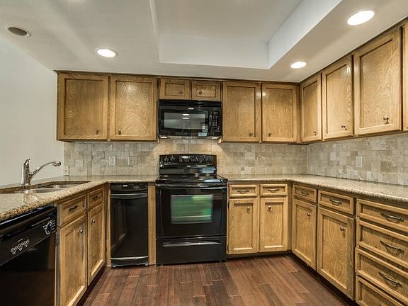 Granite &  Tri-Patterned Travertine backsplash.