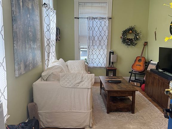 This is how current tenant has living room arranged. This is a very sunny unit as well with 10 foot ceilings and tall windows.