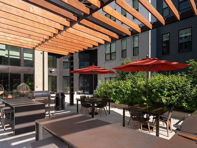Unwind outdoors under the pergola with cozy lounge seating.