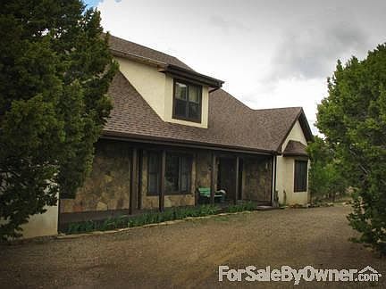 Exterior. Front faces East w/ Pinon Pine, Cedar and Juniper trees growing.
