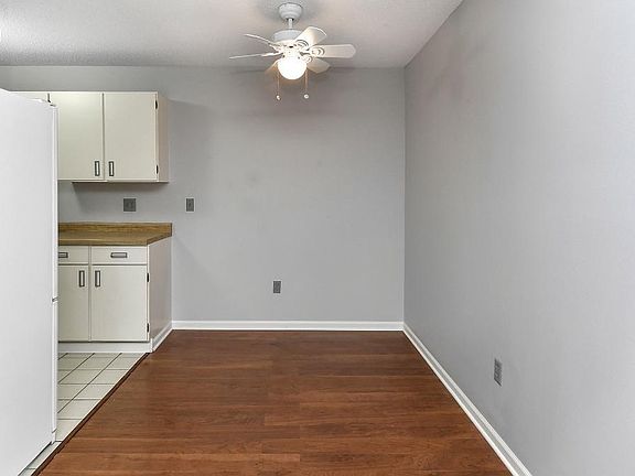 Formal dining room with new flooring and light/fan.