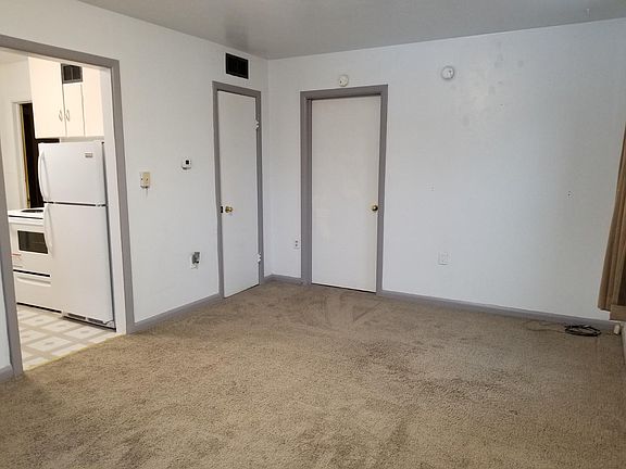 Living room looking at kitchen entrance, coat closet and bedroom door