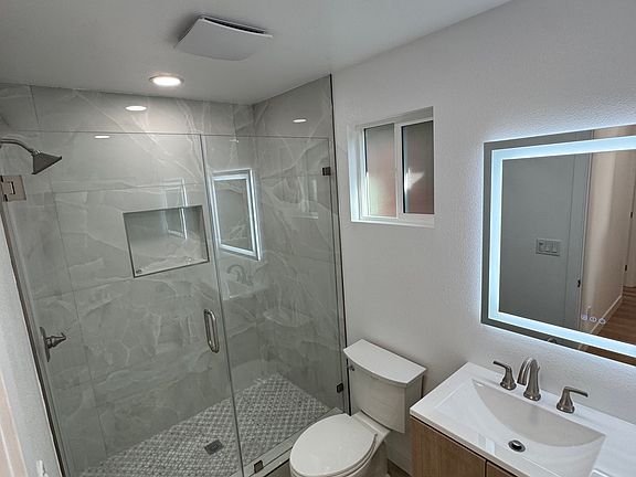 Beautifully new bathroom with glass walk in shower.