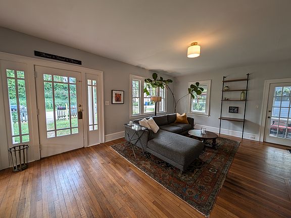The open, airy living room opens to the screened-in porch.