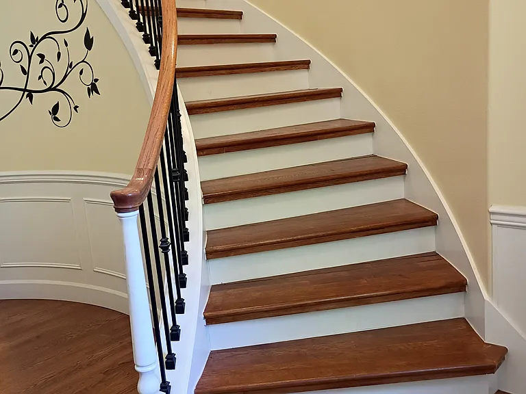 Curved hardwood floor stairs.