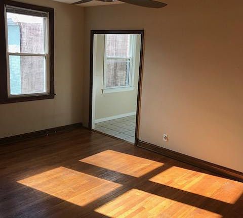 Living Room with Kitchen beyond. Eating area is in front of the far window.