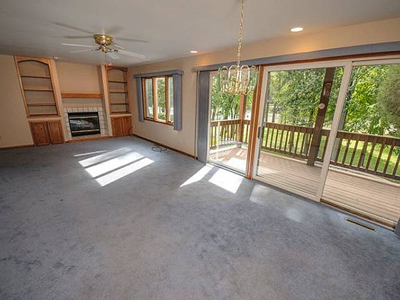 Sliding glass doors offer access to the back yard deck and allow natural light to flow through this generously sized space.