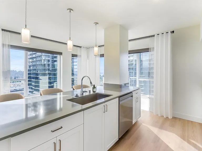 Renovated Package I kitchen with white cabinetry, grey quartz countertops, and hard surface flooring