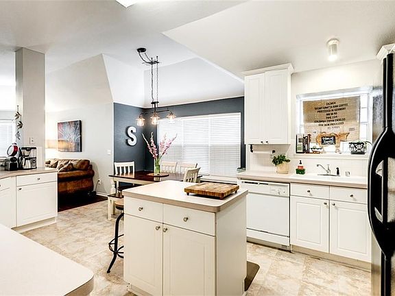 Spacious kitchen with loads of counter space, breakfast bar and island and modern lighting.