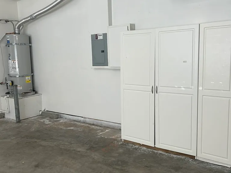 Garage with lots of storage cabinets, freshly painted