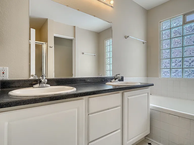 Primary bath with double vanity, soaking tub, shower, toilet