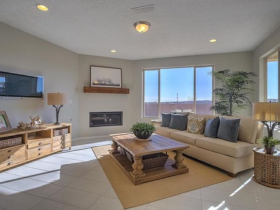 The gathering room has two large window that creates natural lighting with a fireplace to cozy up next to.