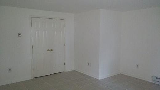 Large Bedroom view facing toward large closet. Note tile floors.