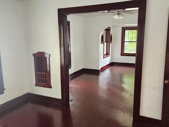 Looking from Dining Room forward into Living Room, and Foyer. Newly refinished painted walls and ceiling, floors and trim newly refinished sanded and stained.