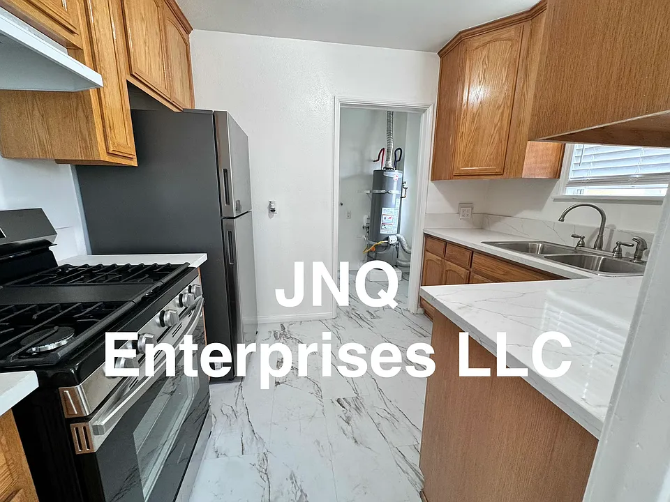 Bright, clean and freshly painted kitchen includes new refrigerator and new stove, new counter tops, and ample cabinet space.