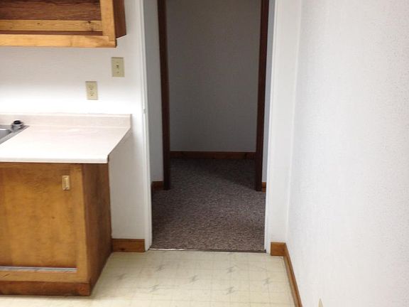 view of kitchen from living room, small closet next to bedro