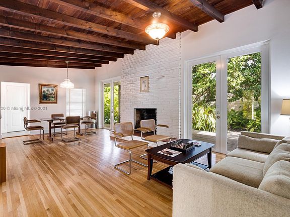 Vaulted wood beamed ceilings, 8' high French doors that open up to patio and Pool, the wood burning fireplace and the hardwood floors will make you want to stay and say, "HOME"!