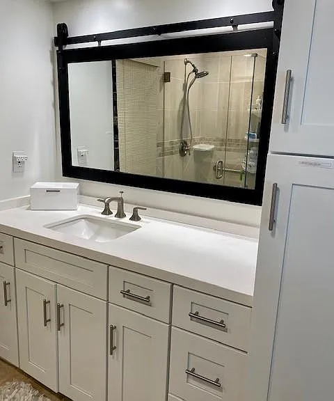 Bathroom with new cabinets, new quartz counter and lighting.