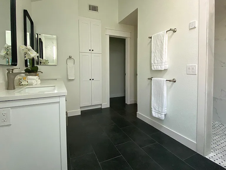 Step into the serene master bathroom featuring a spacious walk-in shower and relaxing soaking tub_your own private spa escape. Unwind in comfort and style after a day of adventure.