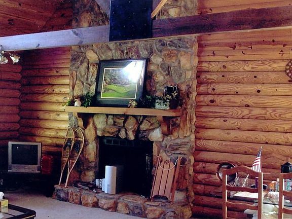 Open floor plan with stone firepace in family room.