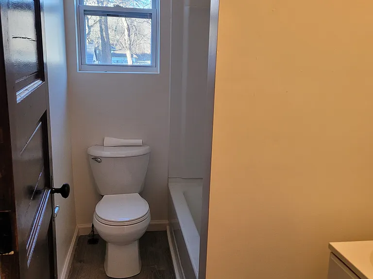 Bathroom with tub, vanity and toilet.