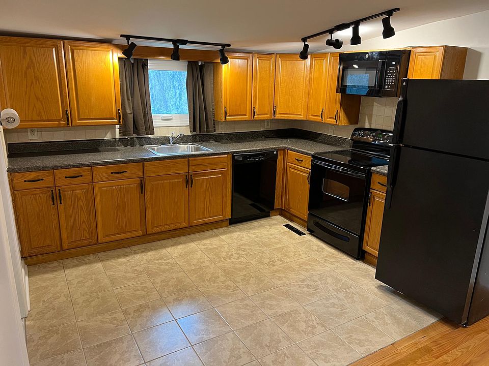 Vaulted Kitchen features track lighting open to space that can be used as Dining or Living- you decide!