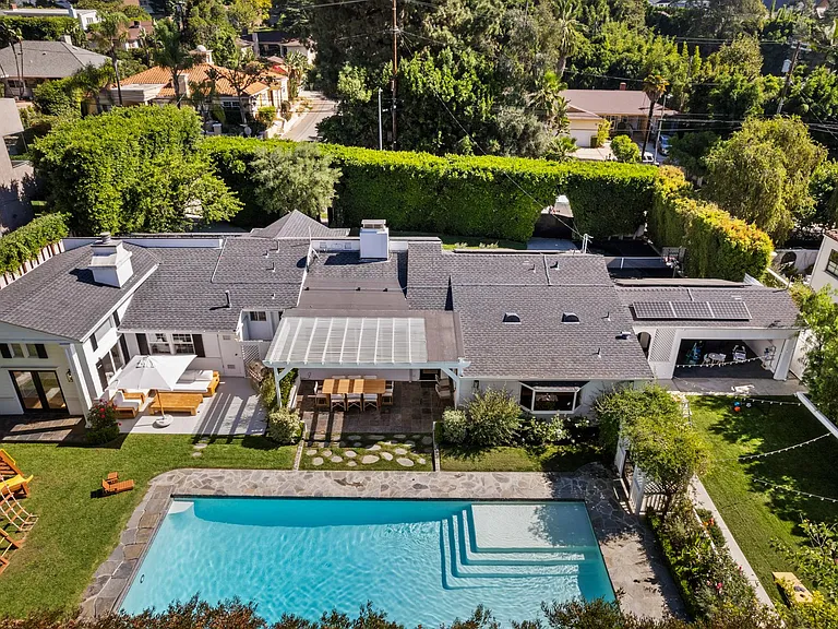 Immerse yourself in the lush outdoor living of this backyard, featuring a playground, patio, and a beautiful pool_ideal for families and relaxation.