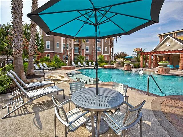 Umbrella covered table and seating with pool view