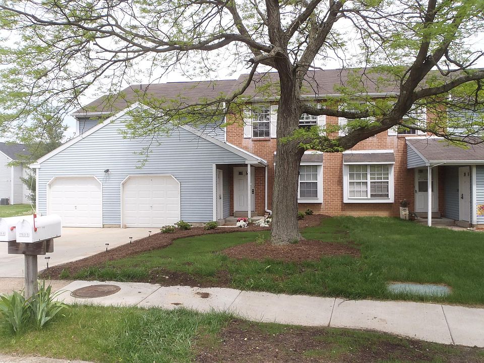 Front view of 1769 Quail Court. 2-car garage plus paved driveway and landscaping.