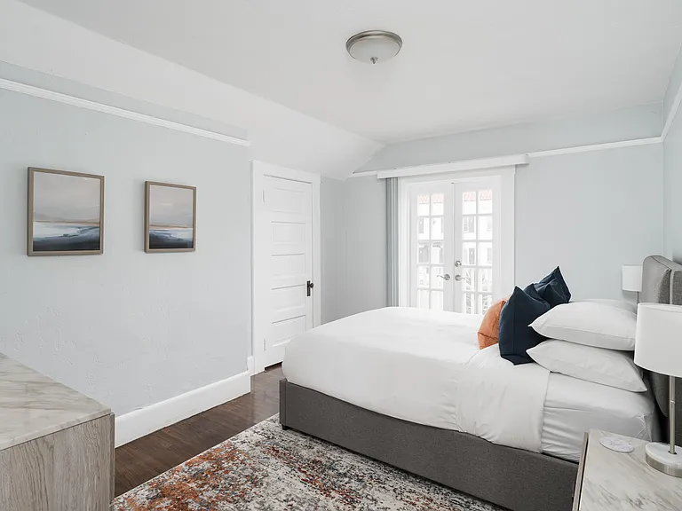 Bedroom 2 - queen size bed with French doors leading to private balcony.