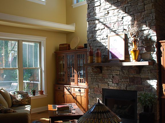 Family room with two-story stone fireplace