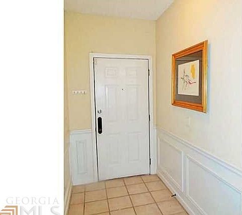 Entry foyer has tile floor and a coat closet