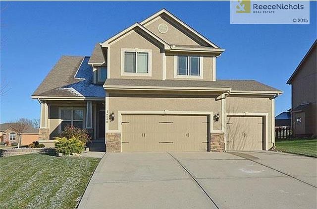 3 car garage with trendy garage door hardware. Timberline roof.