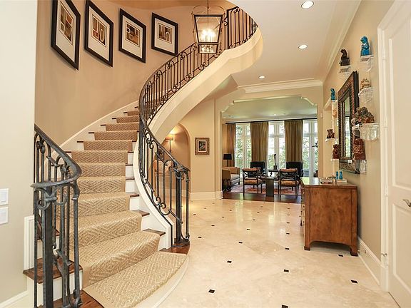 This elegant winding staircase greets you as you open the front door. Limestone tiles with contrast detail make the entryway light and welcoming. The whole of the first floor is wired with built in surround sound speakers.