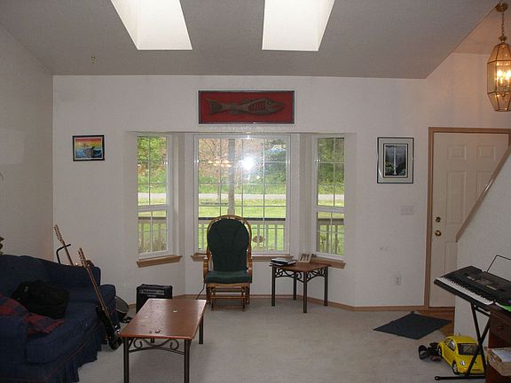 Living Room boasts Vaulted Ceiling, Skylights,and Bay Window 