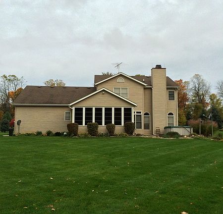Rear view of home and yard